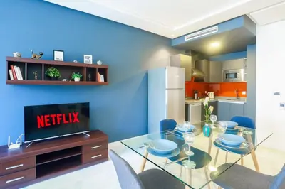a dining room with a glass table and blue walls at #23 New Charming Casablanca Retreat/keyless door in Casablanca