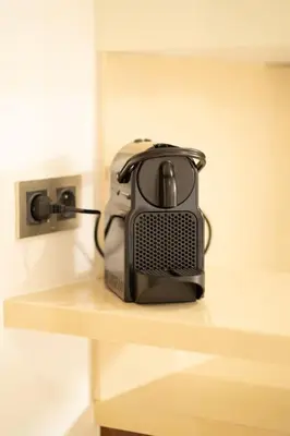 a black and white appliance sitting on a shelf at Keyless Smart door/ New /Free parking/Central in Casablanca