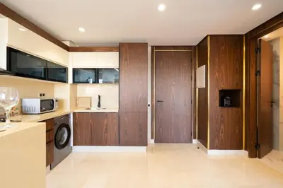 a kitchen with wood paneled cabinets and a sink at Charming & Airy Flat - Perfect for Relaxation in Casablanca