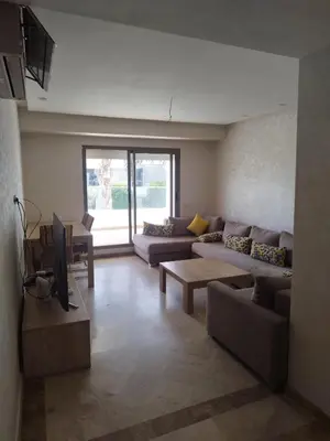 a living room with two couches and a tv at Best appartement pools view at Mansouria in Mohammedia
