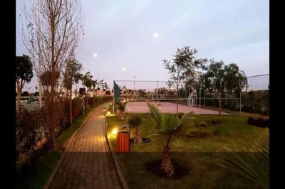 a tennis court in a park with a tennis court at Best appartement pools view at Mansouria in Mohammedia