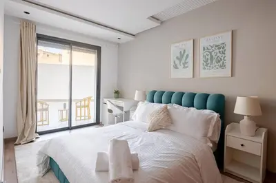 a bedroom with a large bed and a large window at 1 Bedroom with Terrace Casablanca City Center in Casablanca