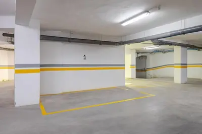 an empty parking garage with yellow and white walls at 1 Bedroom with Terrace Casablanca City Center in Casablanca