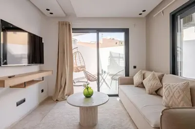a living room with a couch and a table at 1 Bedroom with Terrace Casablanca City Center in Casablanca