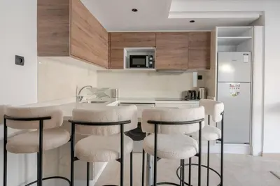 a kitchen with a counter and stools in a room at 1 Bedroom with Terrace Casablanca City Center in Casablanca