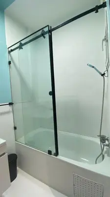 a glass wall in a bathroom with a bath tub at RABAT RESIDENCE - Apartments in Rabat