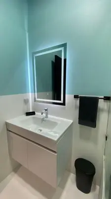 a white bathroom with a sink and a mirror at RABAT RESIDENCE - Apartments in Rabat