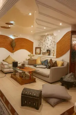 a living room with a couch and a table at Luxury duplex in the centre of Maarif in Casablanca