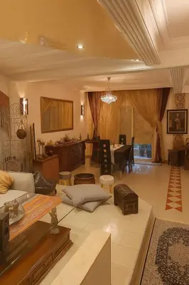 a living room with a couch and a table at Luxury duplex in the centre of Maarif in Casablanca
