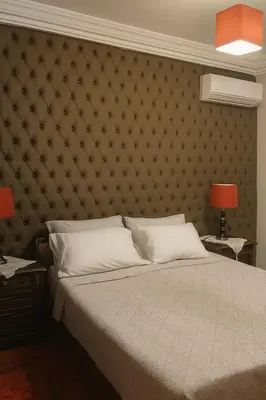 a bedroom with a large bed with a padded wall at Luxury duplex in the centre of Maarif in Casablanca