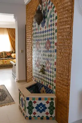 a bathroom with a shower with a mosaic wall at Luxury duplex in the centre of Maarif in Casablanca