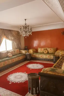 a living room with a couch and a chandelier at Luxury duplex in the centre of Maarif in Casablanca