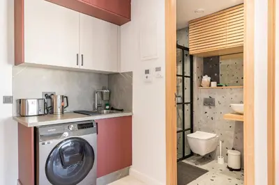 a laundry room with a washing machine and a toilet at Tribeca 3 - Casablanca Center in Casablanca