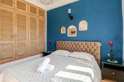 a bedroom with a large bed with blue walls at 4 min à pied de la Plage, 3 BR, Piscine, Parking in Skhirat