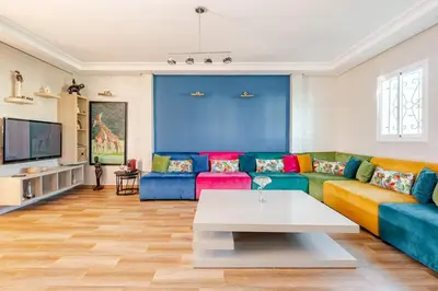 a living room with a couch and a table at 4 min à pied de la Plage, 3 BR, Piscine, Parking in Skhirat