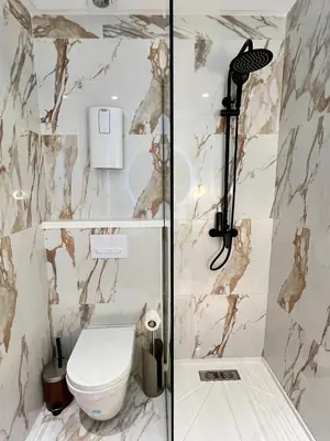 a bathroom with a toilet and a shower at Cozy Studio à Palmier avec Roof top et Parking in Casablanca