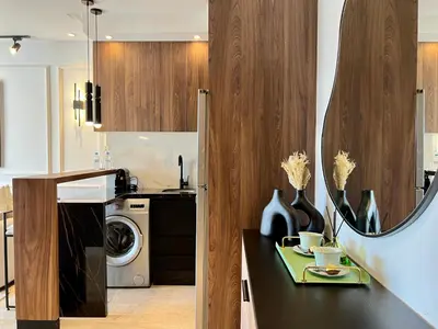 a kitchen with a black counter with vases on it at Cozy Studio à Palmier avec Roof top et Parking in Casablanca