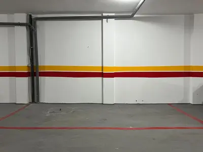 a garage with red white and yellow stripes on the wall at Cozy Studio à Palmier avec Roof top et Parking in Casablanca