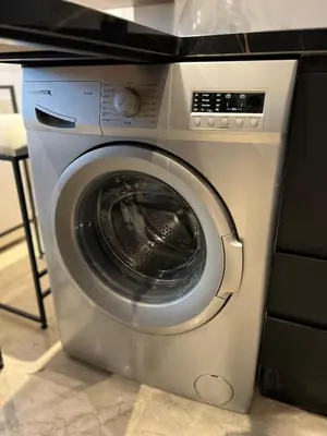 a washing machine is sitting in a kitchen at Cozy Studio à Palmier avec Roof top et Parking in Casablanca