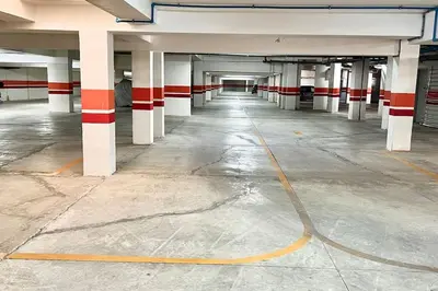 an empty parking garage with red and white columns at N9 Appartement pied sur mer, La Corniche Rabat in Rabat