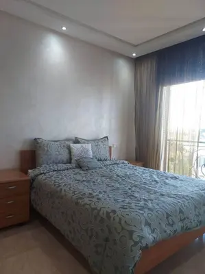 a bedroom with a large bed and a window at Beautiful 3BR apartment in Hay Riad Rabat in Rabat