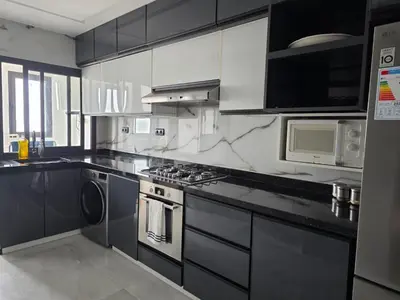 a kitchen with a stove and a microwave at Beautiful 3BR apartment in Hay Riad Rabat in Rabat