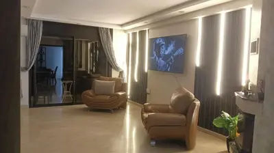 a living room with two chairs and a laptop in it at Beautiful 3BR apartment in Hay Riad Rabat in Rabat