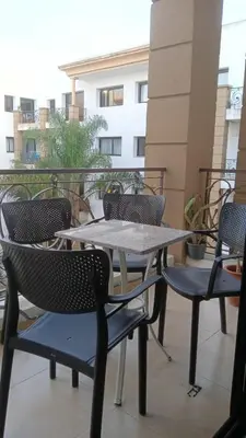 a group of tables and chairs on a balcony at Beautiful 3BR apartment in Hay Riad Rabat in Rabat