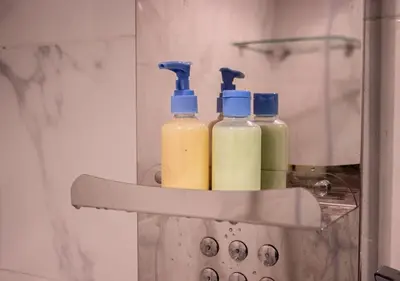 three bottles of detergent are sitting in a shelf at R101- Cosy and stylish apartment with King Size Bed- Belvédère in Casablanca