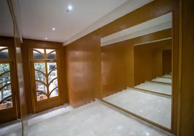 an empty room with wooden walls and windows at R101- Cosy and stylish apartment with King Size Bed- Belvédère in Casablanca