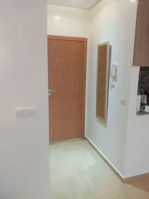 a room with a wooden door and a tile floor at Cocon cozy à Mansouria Mer, piscines et nature in Mansouria