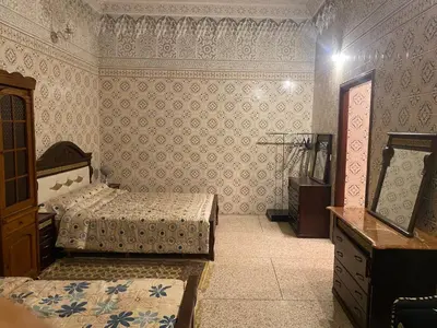 a bedroom with two beds and a dresser in it at Appartement oulfa in Casablanca