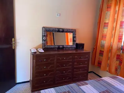 a bedroom with a dresser with a mirror on it at Appartement oulfa in Casablanca