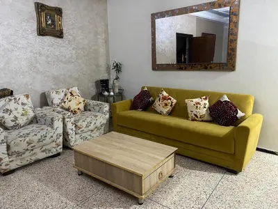 a living room with a couch and a coffee table at Grand appartement 3 chambre in Casablanca