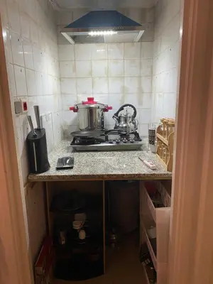 a kitchen with a stove with two pots on it at Grand appartement 3 chambre in Casablanca