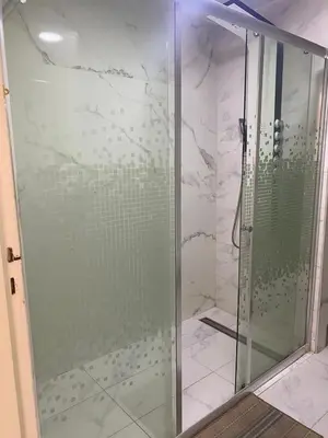 a shower with a glass door in a bathroom at Grand appartement 3 chambre in Casablanca