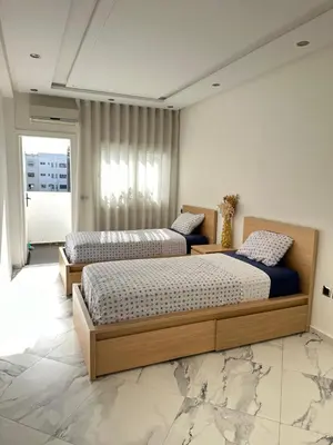 a bedroom with two beds and a window at Chambre à Agdal Rabat dans un appartement partagé in Rabat