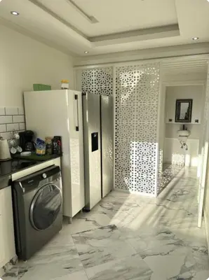 a kitchen with a refrigerator and a washing machine at Chambre à Agdal Rabat dans un appartement partagé in Rabat
