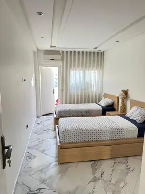 three beds in a room with marble floors at Chambre à Agdal Rabat dans un appartement partagé in Rabat