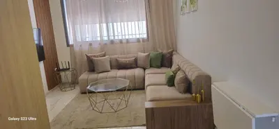 a living room with a couch and a table at Cosy & Confort Studio près de l'aéroport in Nouaceur
