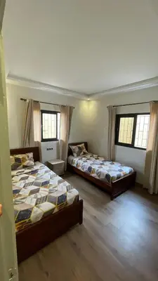 two beds in a room with two windows at Modern rez de villa, jack beach Tamaris, Dar Bouaza in Casablanca