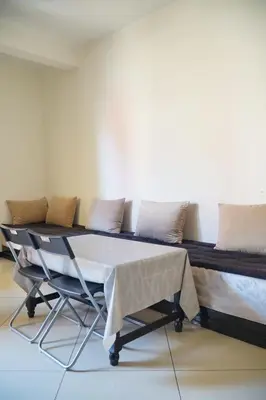 a table and chairs in a room with a couch at Le Calme a Temara in Temara