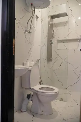 a bathroom with a toilet and a sink at Le Calme a Temara in Temara