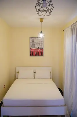 a bedroom with a bed in a room with a window at Le Calme a Temara in Temara