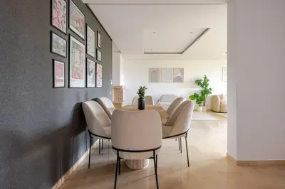a dining room with a table and chairs at TT Holidays Hay Riad Prestigia in Rabat