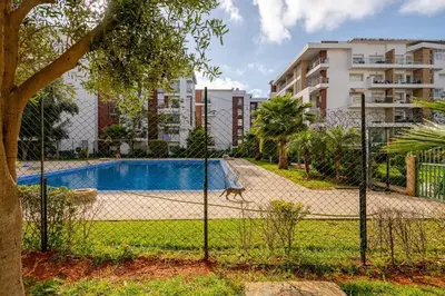 a fence in front of a swimming pool at TT Holidays Hay Riad Prestigia in Rabat
