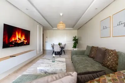 a living room with a couch and a fireplace at TT Holidays Hay Riad Prestigia in Rabat