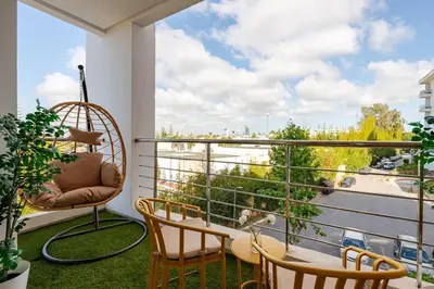a balcony with a table and chairs and a view at TT Holidays Hay Riad Prestigia in Rabat