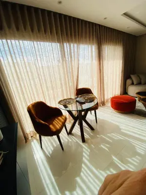a room with two chairs and a table in front of a window at Atlantic Suite View 2 in Casablanca