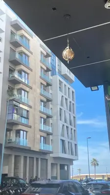 a tall building with cars parked in front of it at Atlantic Suite View 2 in Casablanca